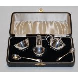 A cased silver three-piece cruet set, comprising open salt, lidded mustard and pepperette,