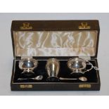 A mid 20th century cased silver three piece cruet set, maker Charles S Green & Co Ltd,