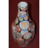 A large Japanese floor vase, each central panel decorated with figures amongst landscapes,