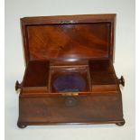 An early Victorian mahogany tea caddy of sarcophagus form having a fitted interior (missing the