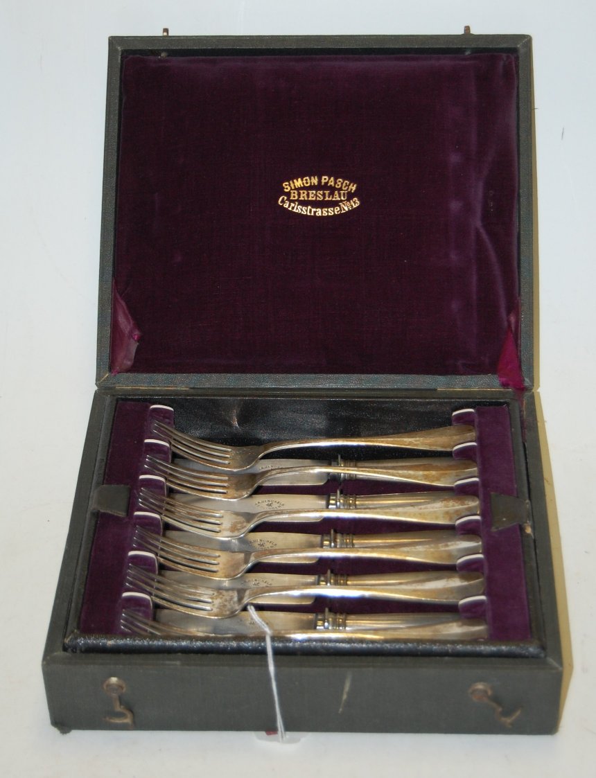 A cased canteen of German white metal six-place setting cutlery,