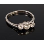 A platinum diamond three stone ring, the centre claw set brilliant weighing approx 0.2ct, 2.