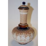 A Doulton Lambeth bottle vase and cover, decorated with floral sprigs on a spiral ground,