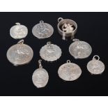 A collection of silver St Christopher pendants of various designs,