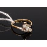 An 18ct gold diamond three stone ring, the shoulders further set with diamond points, 2.