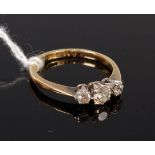 An 18ct gold diamond three stone ring, the centre brilliant weighing approx. 0.2ct, 2.