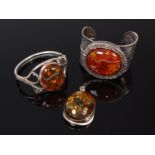 A modern silver and large amber set bangle, one other,