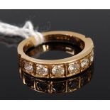 An 18ct gold diamond set half eternity ring arranged as seven illusion set brilliants each weighing