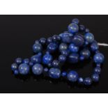 A beaded and graduated lapis lazuli single string necklace,