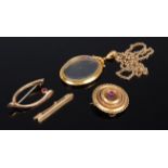 A 9ct gold ruby set wishbone brooch, together with an 18ct gold bar brooch,