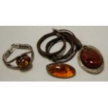 A ladies amber set bangle, in white metal mount,