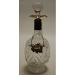 A cut glass pedestal decanter and stopper, having silver collar, h.