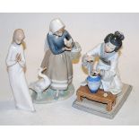 A Lladro figure of a kneeling geisha girl with vase and flowers, printed mark verso, h.