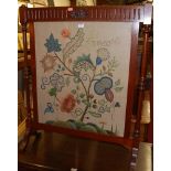 An Edwardian walnut and floral needlework inset fire screen, w.