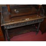 A late 19th century Continental heavily carved oak two drawer writing desk,