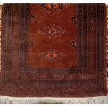 A Persian woollen small brown ground rug,