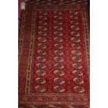 A Persian woollen red ground Bokhara rug,