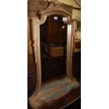 A French style giltwood wall mirror, of shaped form, having integral lower tray shelf,