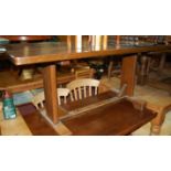 A planked elm trestle end refectory table,