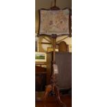 An early Victorian faded rosewood and floral needlework inset pole screen,