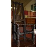 An antique low relief carved oak slatback panelled seat single dining chair