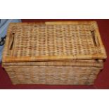 A pair of graduated wicker hamper type boxes