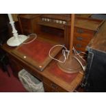 An Edwardian walnut twin pedestal writing desk, having central hinged sloping surface,