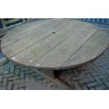 A large contemporary teak circular garden table, dia.