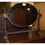 A small early 20th century oak oval swing toilet mirror,