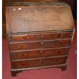 A George III mahogany slopefront four drawer writing bureau (lacking handles and requires