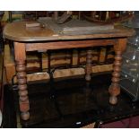 An early 20th century oak round cornered extending dining table,