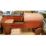 A 1950s child's tinplate pedal car, finished in red,