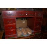 A reproduction mahogany effect and gilt tooled green leather inset twin pedestal writing desk, w.