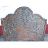 A heavy cast iron fireback, decorated with standing lion amongst foliage,