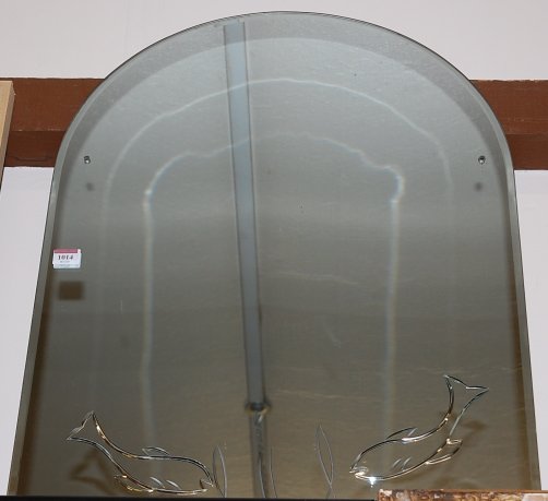 An unframed wall mirror, with bevelled fish decoration,