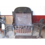 A Gothic Revival cast iron fire basket, having integral fireback and fire dogs,