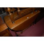 An early 20th century barleytwist oak dropleaf dining table,