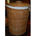 A large wicker circular laundry box and cover, dia.