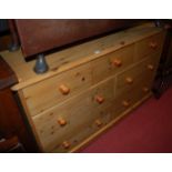 A modern pine round cornered side chest, fitted with seven drawers, w.