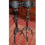 A pair of black painted wrought iron plant stands, in the Gothic taste, h.