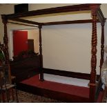 A contemporary carved mahogany four poster bed,