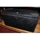 A leather clad and studded hinged top travelling trunk, having end carry handles,