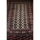 A Persian woollen cream ground Bokhara rug,