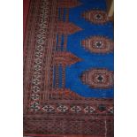 A Persian woollen blue ground Bokhara rug, having multiple trailing tramline borders,