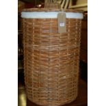 A circular wicker laundry box and cover dia.