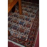 A Persian woollen rug, having geometric floral field within multiple trailing tramline borders,