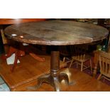 A 19th century provincial oak circular tilt-top pedestal tripod table, dia.