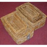 Two sets of three wicker graduated carrying baskets,