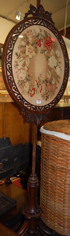 An early Victorian rosewood and floral needlework inset pole screen