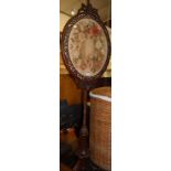 An early Victorian rosewood and floral needlework inset pole screen